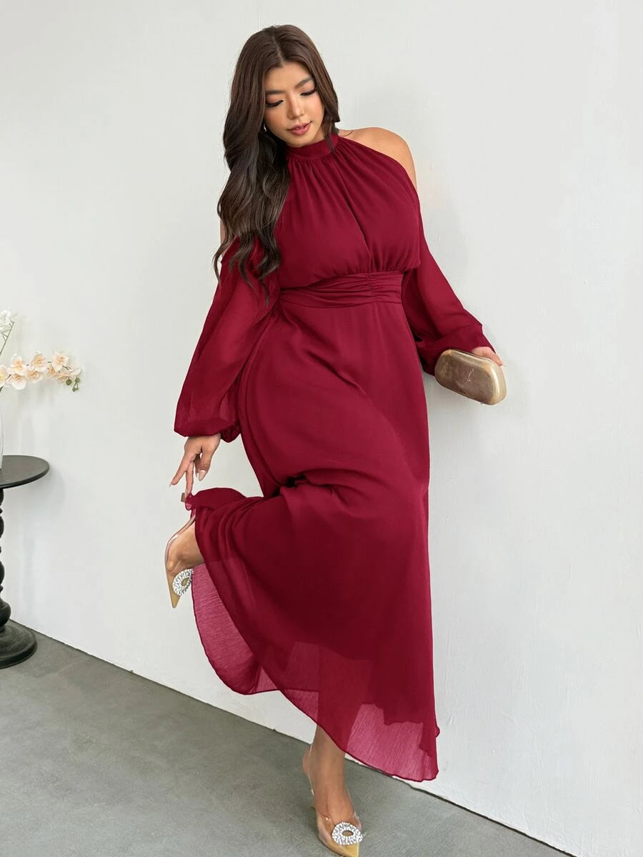 Angled front view of ruby red plus size halter cold-shoulder maxi dress