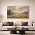 Shepherd and sheep landscape canvas in a gold-toned frame above a sofa and coffee table