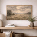 Horizontal pastoral canvas depicting a shepherd and flock above a console with neutral decor