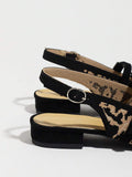 Side heel view of leopard print slingback flats with adjustable back strap and low block heel