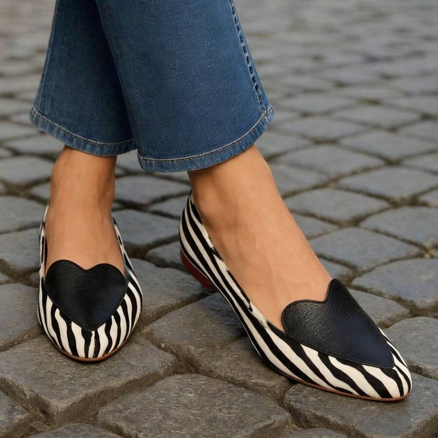 Front view of zebra stripe flats showing black hearts and rounded toes