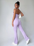 Back view showing the open racerback and long flared legs of lavender unitard