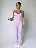 Front view of lavender racerback flare-leg workout jumpsuit with plum trim