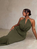 Seated view of army green halter evening dress showing draped bodice and ruched waist