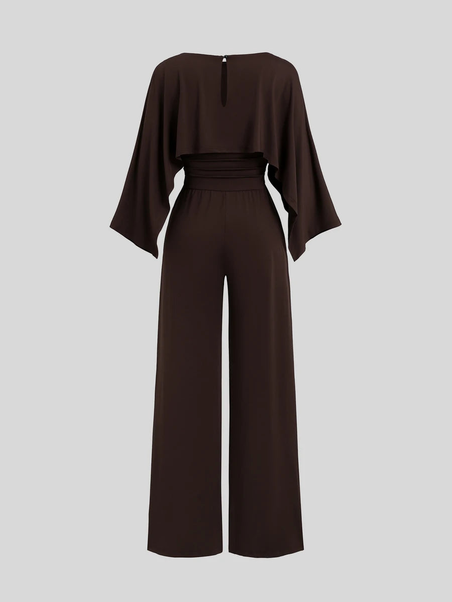 Front view of dark brown cape-sleeve wide-leg jumpsuit with a ruched high waist