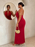 Side back view of red backless halter maxi dress with fitted long skirt