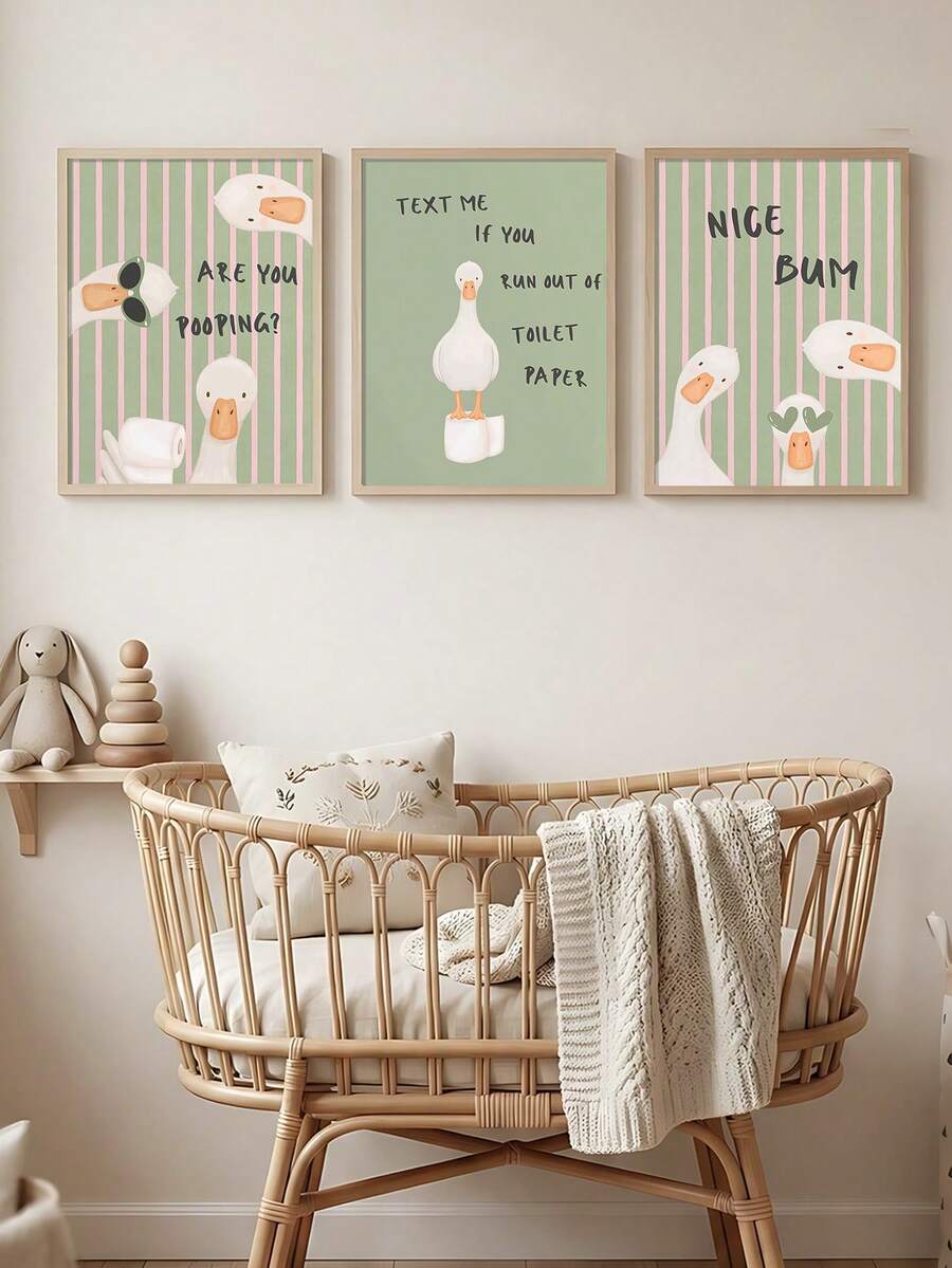 Set of three framed funny goose bathroom canvas prints above a wicker bassinet