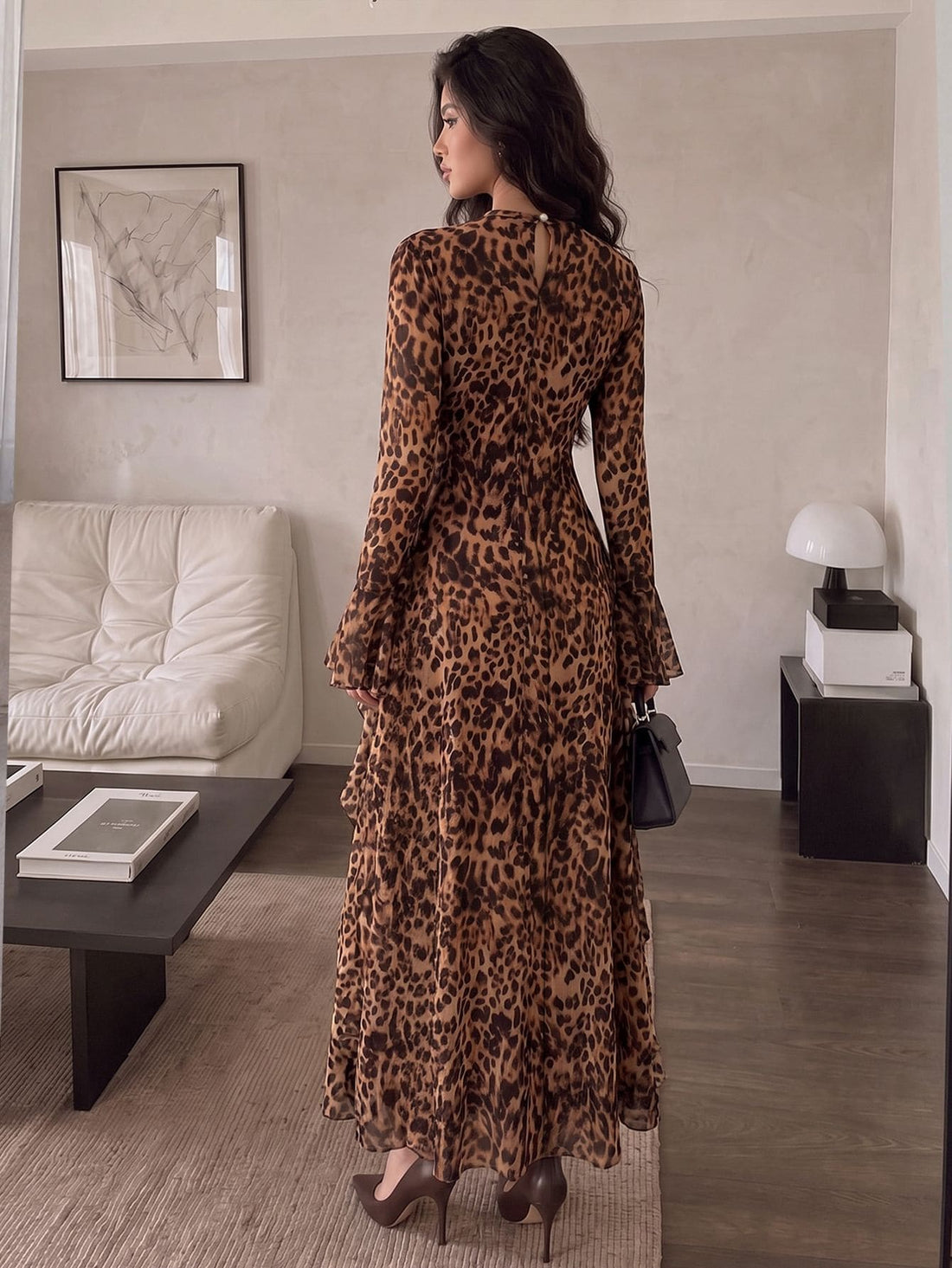 Front view of a woman wearing a brown leopard-print long-sleeve maxi dress with ruffled skirt and flounced cuffs