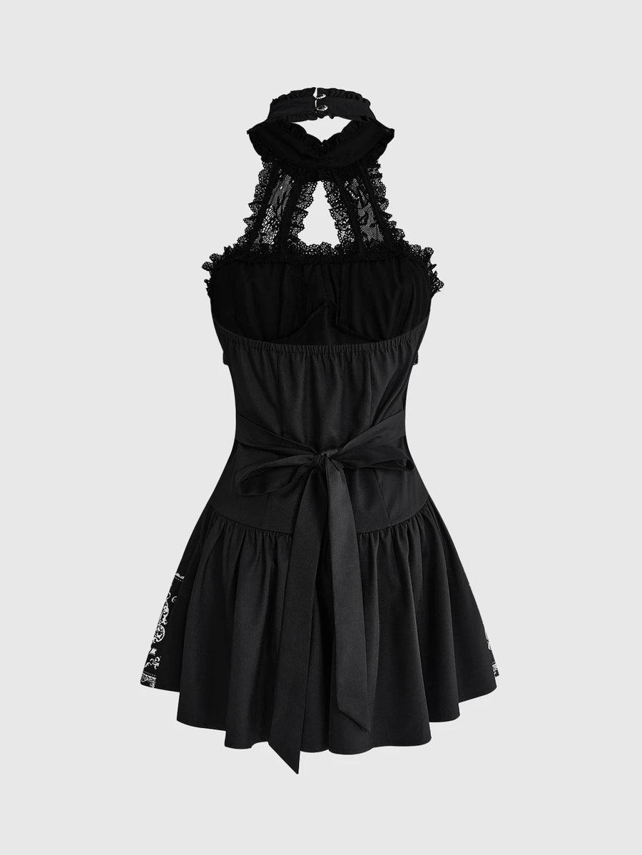 Front view of black gothic halter mini dress with white graphic print, lace trim and bow