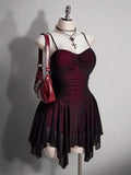 Angled front view of burgundy and black ruched gothic vampire mini dress with sheer skirt overlay