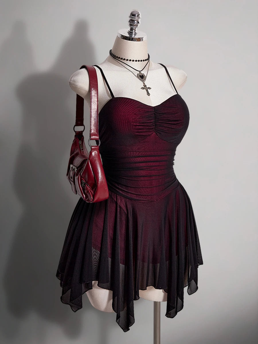 Angled front view of burgundy and black ruched gothic vampire mini dress with sheer skirt overlay