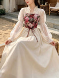 Seated view of apricot floral cottagecore maxi dress with ribbon lacing