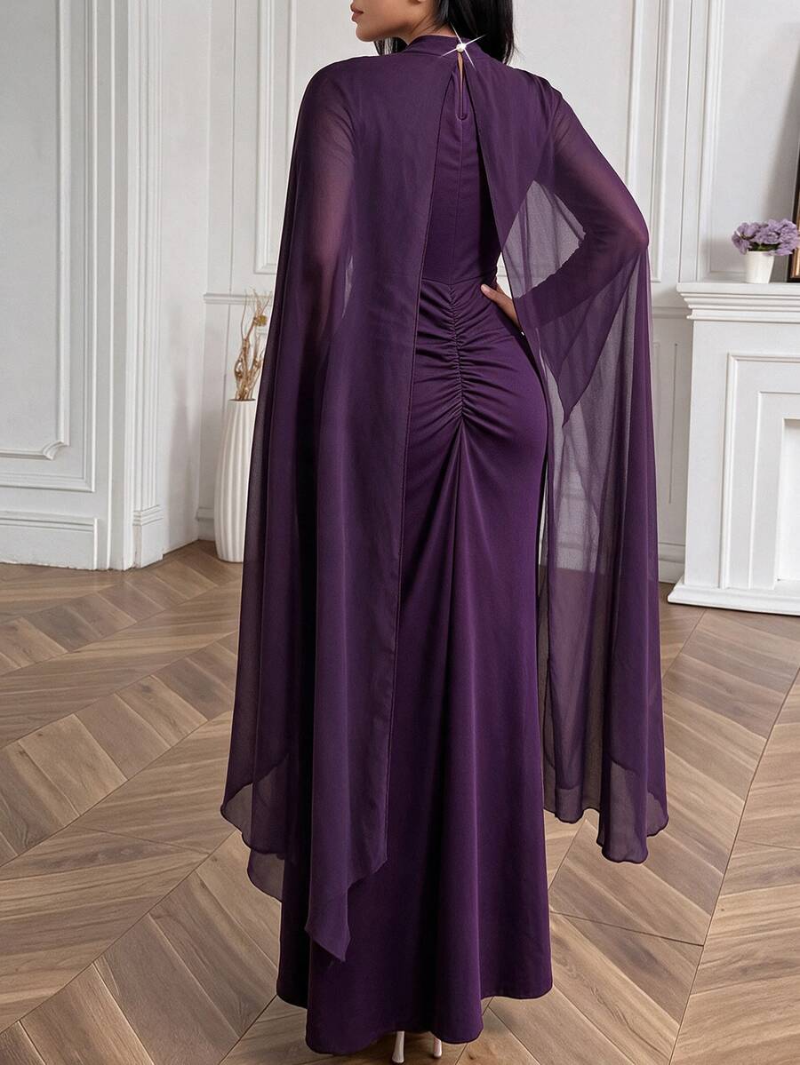 Front view of purple floor-length cape-sleeve gown with crystal waist embroidery and high neckline