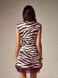Back view of burgundy patterned mini dress showing center zipper and lace trim