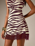 Close-up of burgundy zebra stripes and dark floral lace on satin-look dress