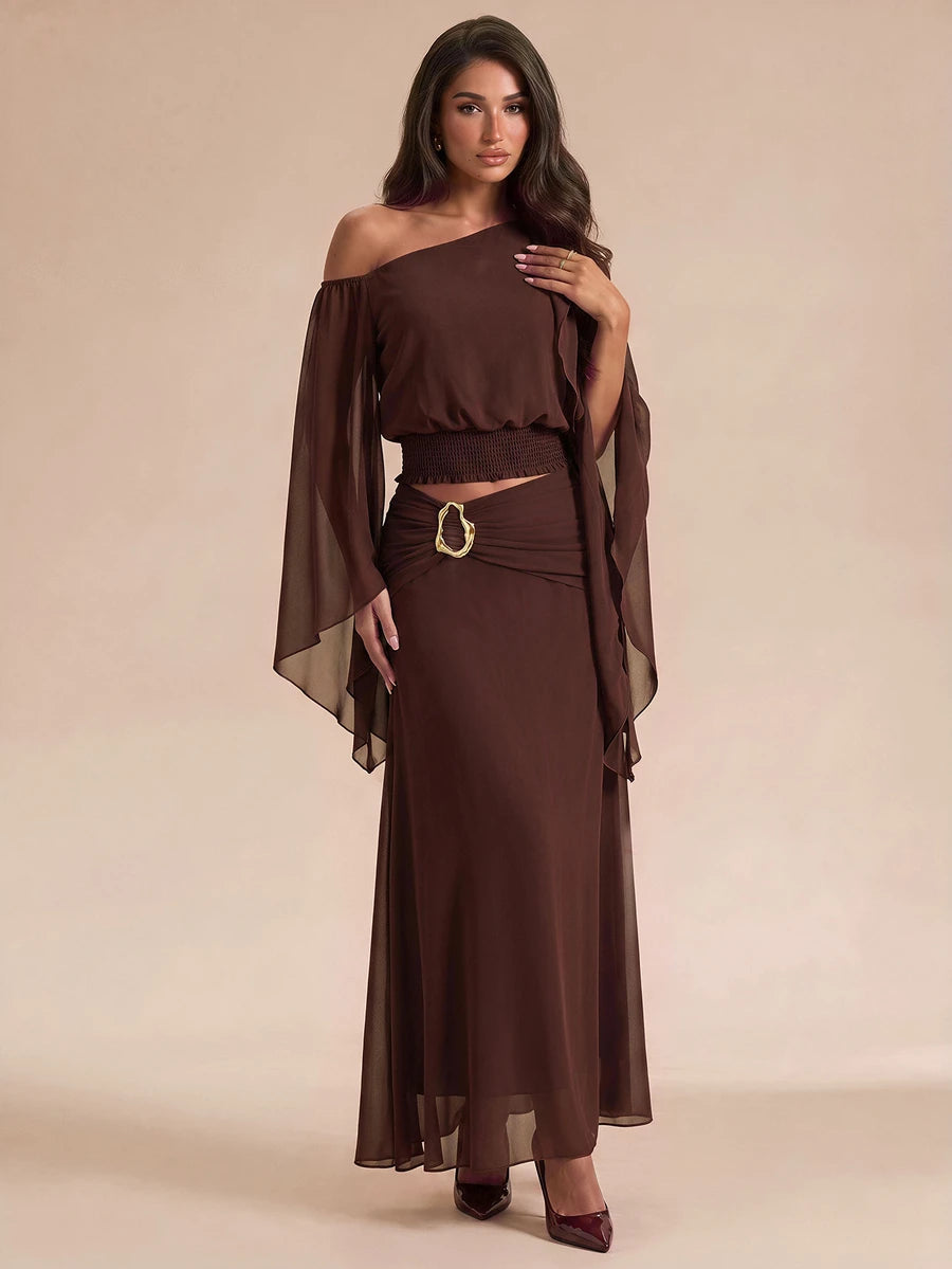 Side view of brown chiffon crop top and high-rise maxi skirt with gold buckle