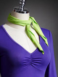 Close-up of purple ruched V-neck crop top with lime-green scarf from Halloween costume set