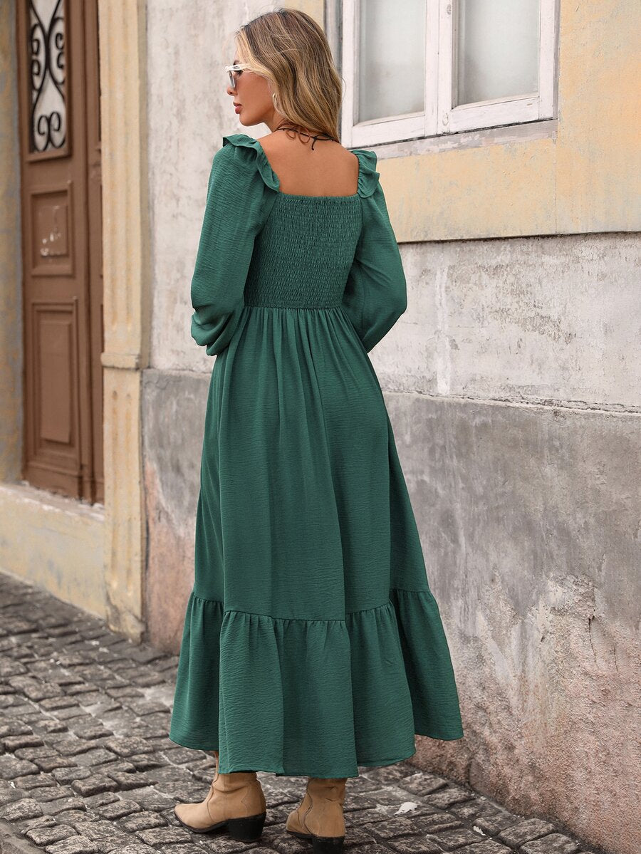 Back view of dark green long sleeve midi dress with smocked square back