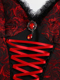 Close view of red gemstone pendant and red ribbon corset lacing on black mini dress