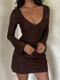 Close front view of fitted brown floral V-neck dress with long sleeves