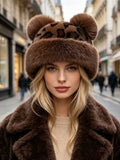 Front view of dark leopard-print bucket hat with brown plush brim and bear-ear accents