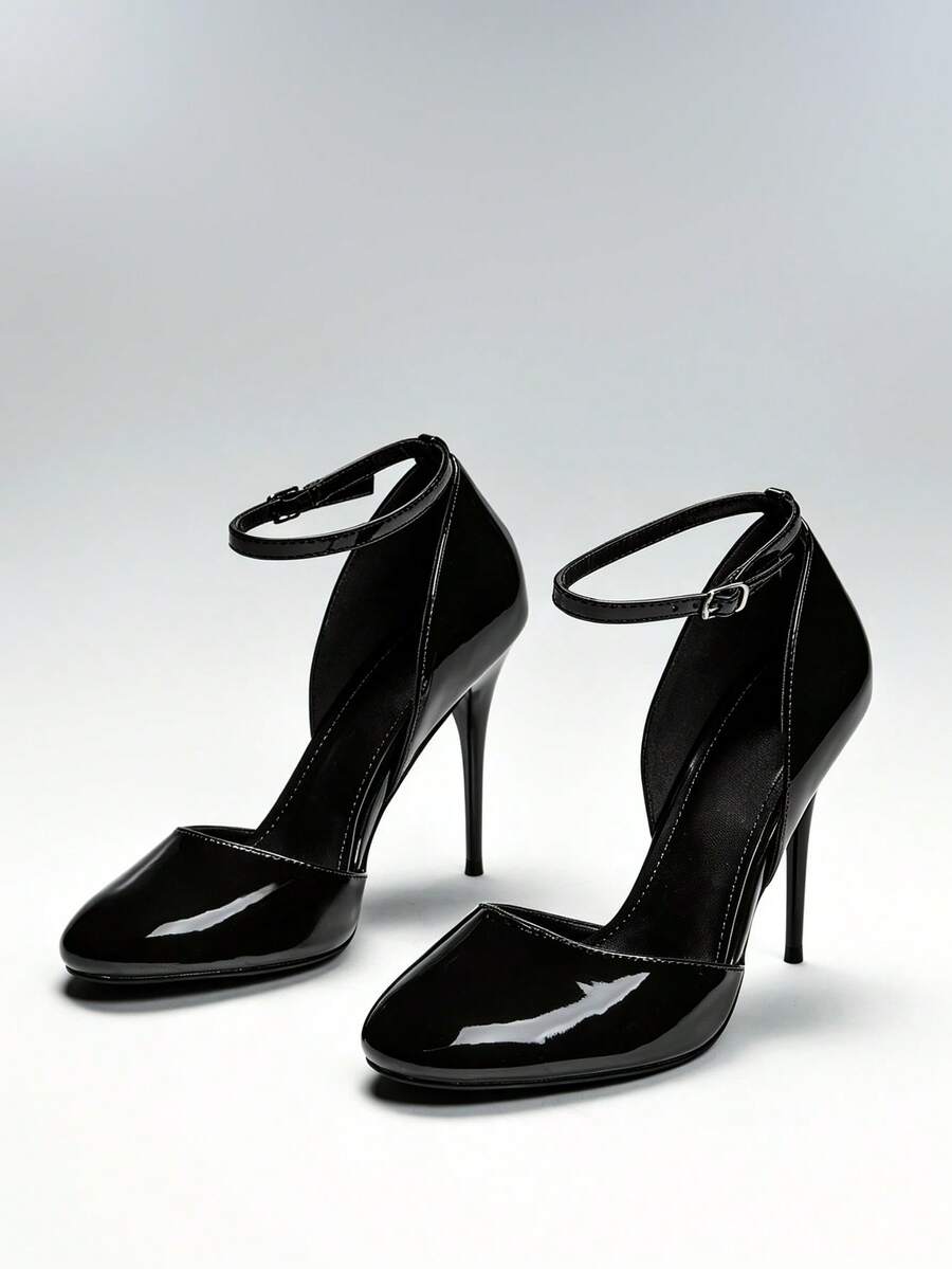 Pair of black patent closed-toe stiletto pumps with ankle buckles