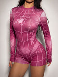 Close-up front view of burgundy pink spider graphic and web print long sleeve romper