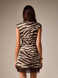 Front view of zebra-print mini dress with sleeveless mock-neck cut and dark lace hem