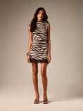 Full-length front view of black-and-ivory zebra mini dress styled with heels for evening
