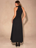 Back view of black halter A-line maxi dress with long flowing skirt