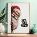Close view of framed Santa wash your hands canvas against a teal wall with tabletop decor
