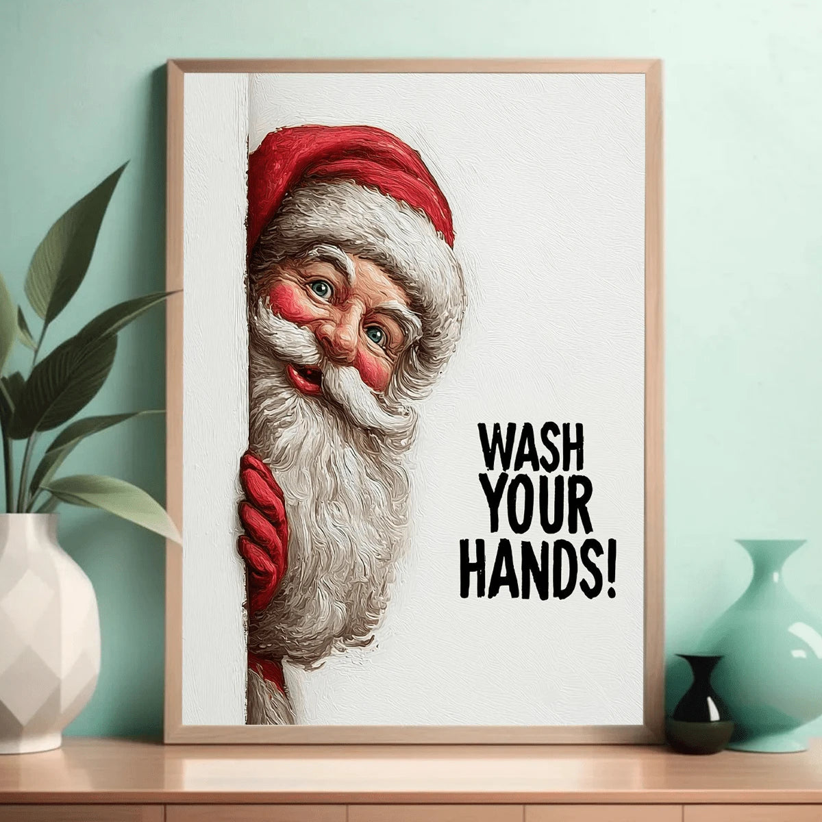 Close view of framed Santa wash your hands canvas against a teal wall with tabletop decor