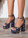 Front view of navy blue gold floral open-toe platform heels