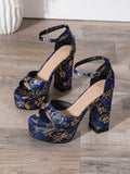 Pair of navy blue floral platform heels with tall block heels and ankle buckles