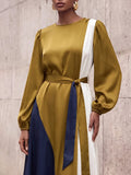 Close-up of waist tie, gathered bishop sleeve and ivory colorblock panel