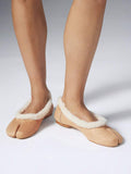 Close-up of sand split-toe flats with faux-shearling lining