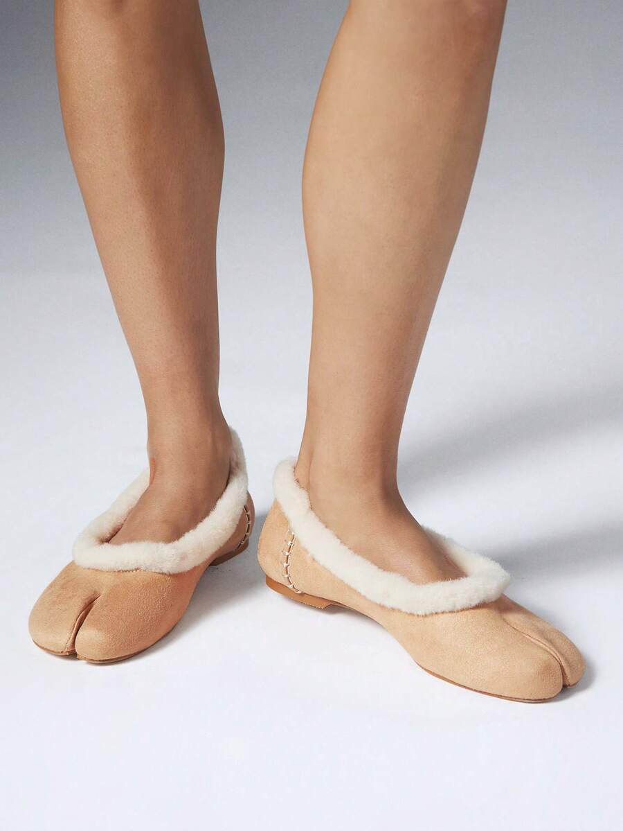 Close-up of sand split-toe flats with faux-shearling lining