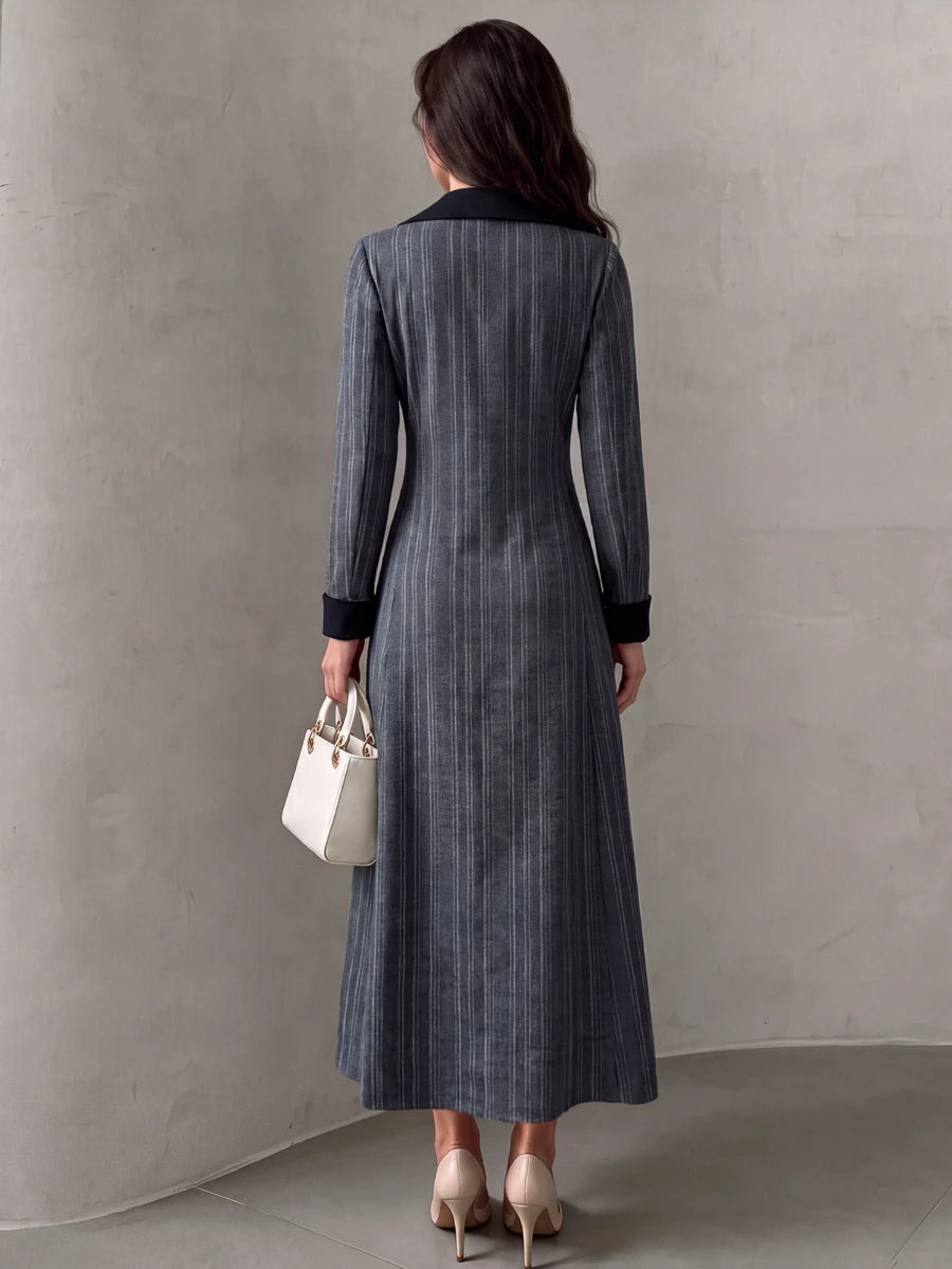 Full front view of grey pinstripe maxi dress with double-breasted lapels and black cuffs
