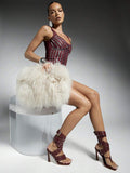 Model styling burgundy studded spiral-wrap stiletto sandals