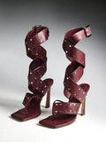 Pair of burgundy studded wraparound high-heel sandals
