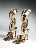 Pair of gold studded wraparound high-heel sandals with square toes