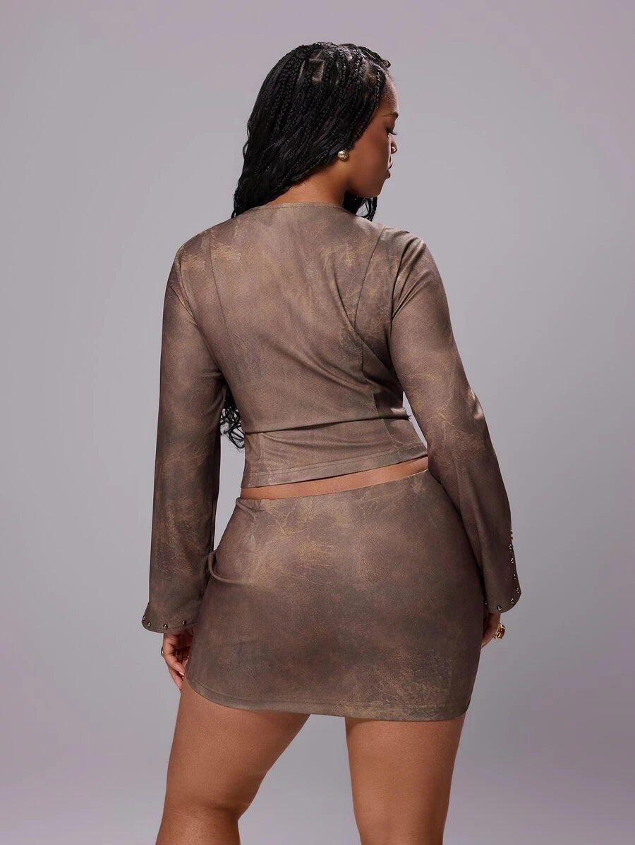 Front view of coffee-brown studded two-piece set with zip-front crop top and mini skirt