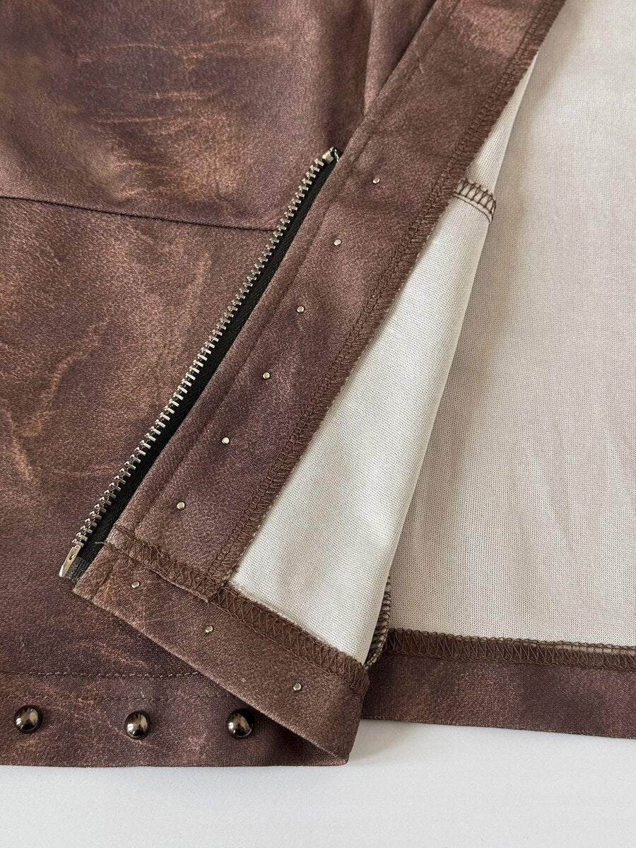 Close-up of brown skirt-set fabric showing zipper, stitching and metal studs