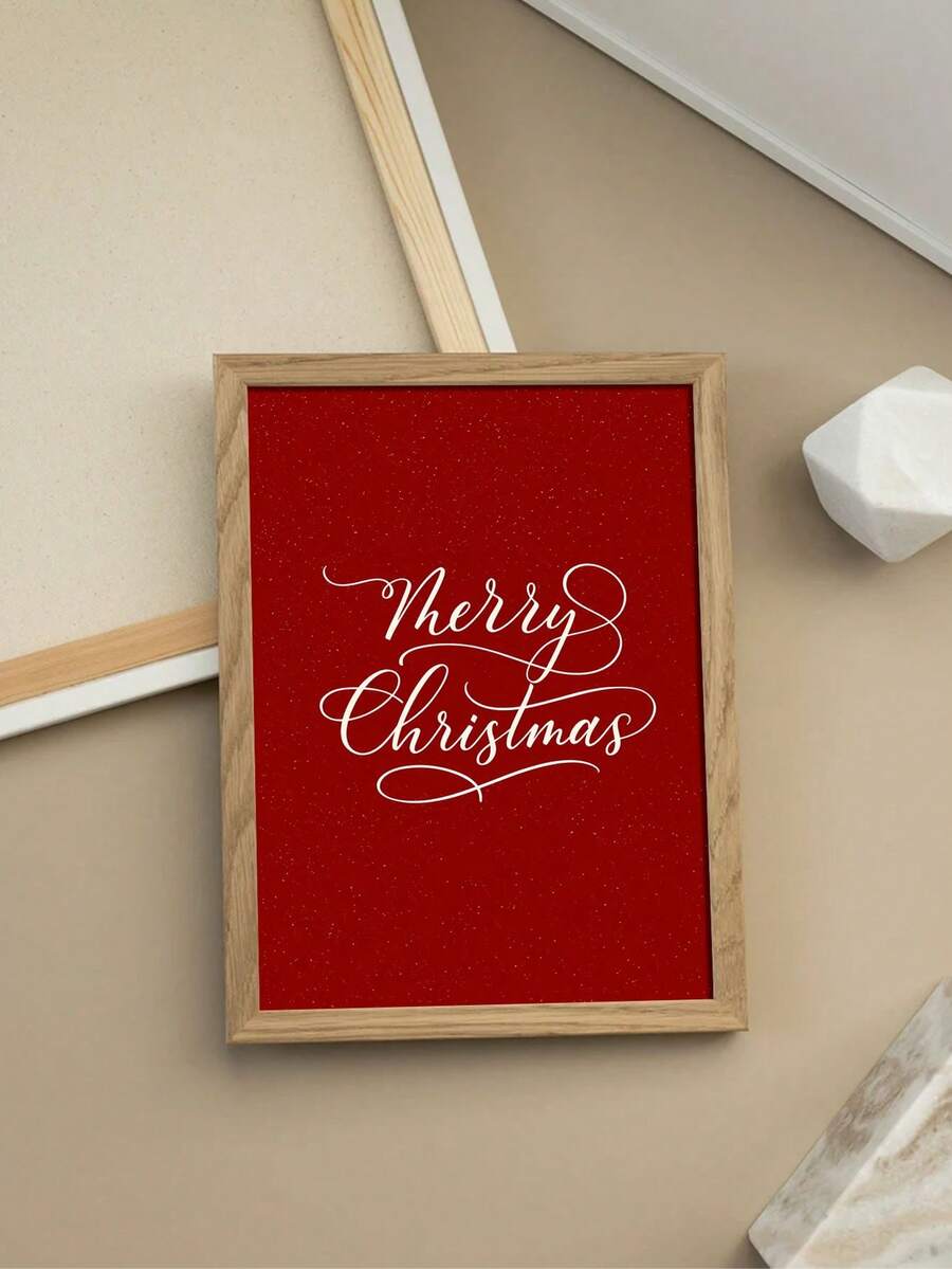 Close-up styled view of red Merry Christmas print against a pale wall with a light wood frame