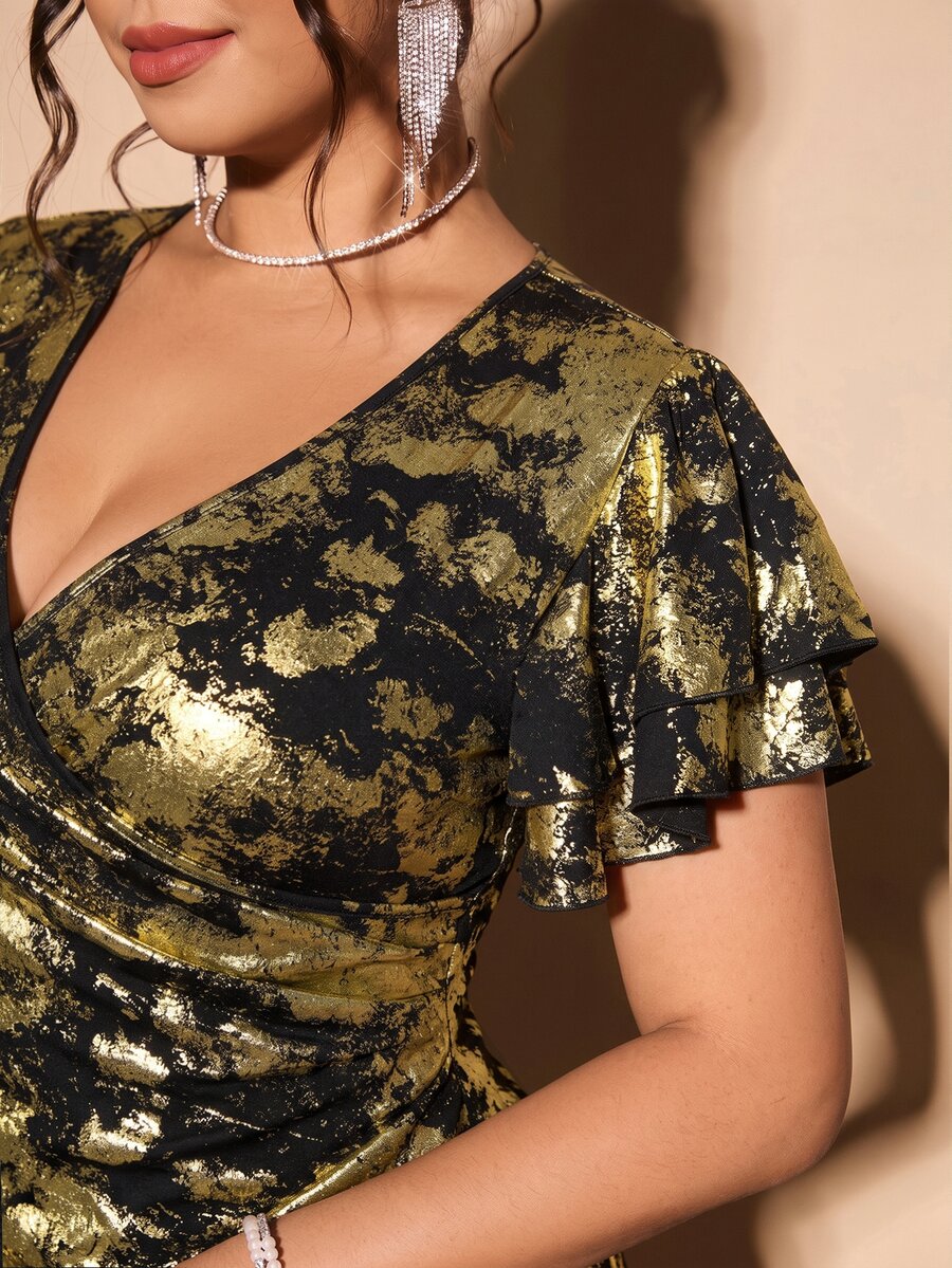 Close-up showing the metallic gold pattern and flutter sleeve detail