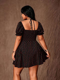 Rear view of black dress with red polka dots, tie-neck straps, smocked back and flared skirt