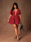 Full-length view of red polka-dot mini dress with V-neck, cinched high waist and flared skirt
