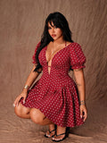 Front view of red polka-dot mini dress with deep V neckline, short puff sleeves and flared hem