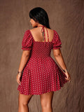 Rear view of red polka-dot mini dress with tie-neck straps, smocked back and puff sleeves
