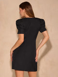 Back view of black puff sleeve mini dress with fitted waist and center back zipper